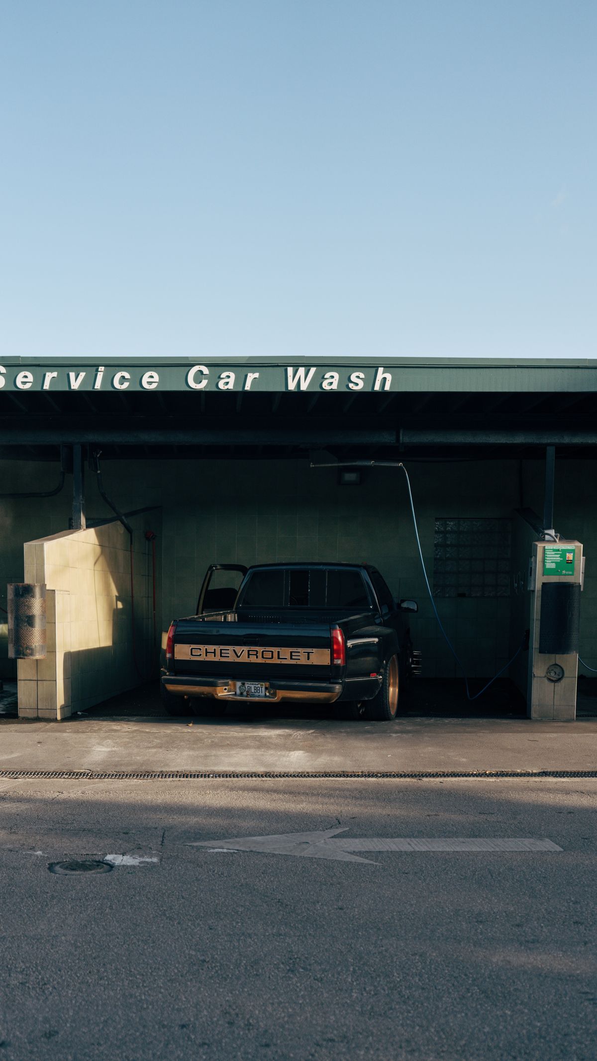 Self-serve car wash bay, full-site view